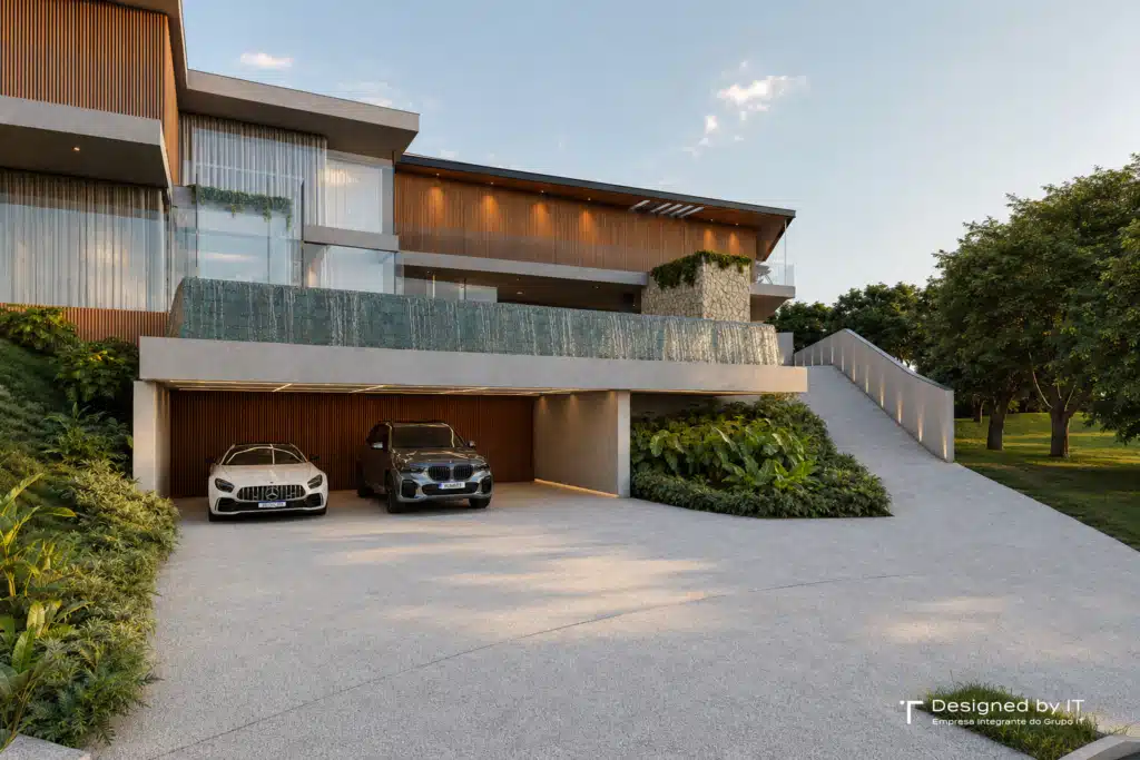Vista frontal da Casa Jundiaí no Bosque do Horto com garagem para dois carros, cascata integrada à fachada e jardim com paisagismo tropical