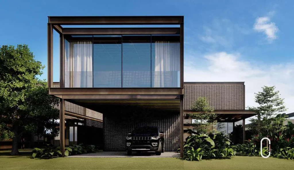 Fachada industrial com estrutura metálica, vidro, elementos escuros e jardim frontal